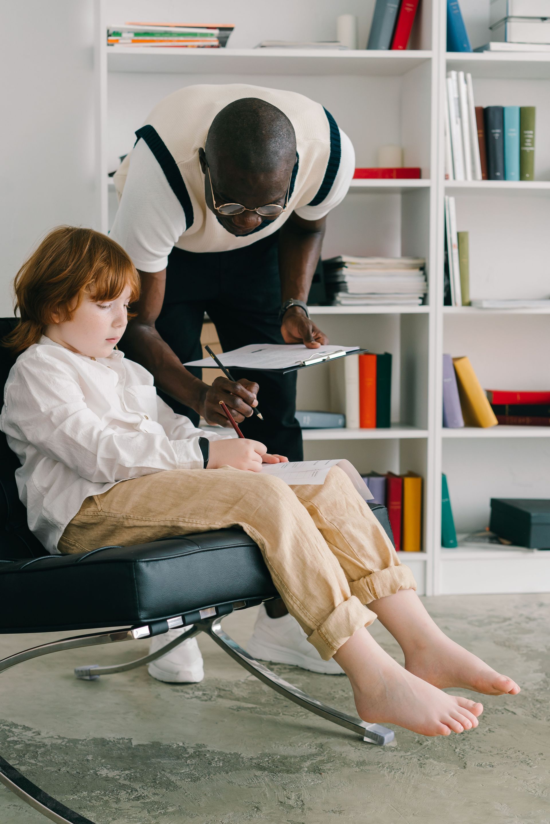Therapist engaging with a child during session in a modern office.
